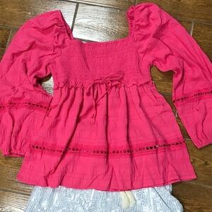 Hot pink boho top with ruffle designs and lace cutouts. Can be worn off shoulder